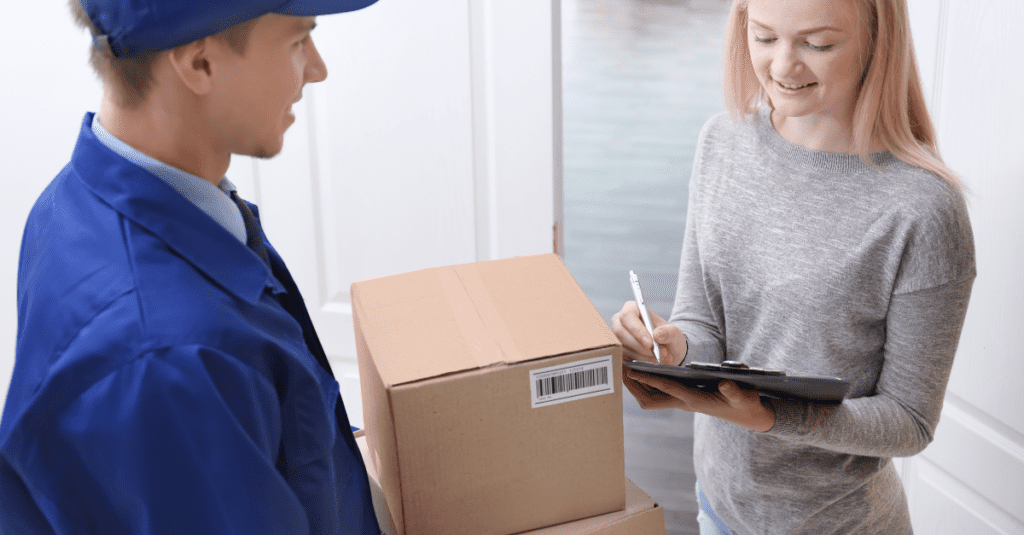 a picture of a woman signing for a delivery package.